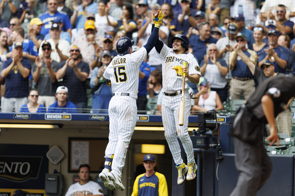Milwaukee Brewers players Tyrone Taylor and Willy Adames